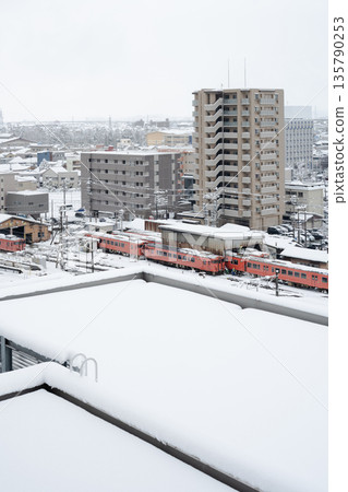 Snow-covered JR Takaoka Station and the rooftop of a building Snow-covered JR Takaoka Station and the rooftop of a building 135790253