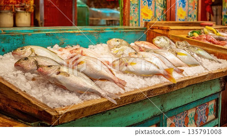 Fresh raw fish displayed on ice in a rustic colorful market stall Fresh raw fish displayed on ice in a rustic colorful market stall 135791008