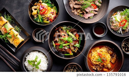 Delicious Asian food spread presented on a dark background Delicious Asian food spread presented on a dark background 135791016