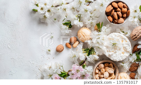 White cherry blossoms, fresh almonds, and sweet cookies on textured background White cherry blossoms, fresh almonds, and sweet cookies on textured background 135791017