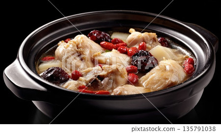 Chinese herbal chicken soup simmering in a black clay pot 135791038