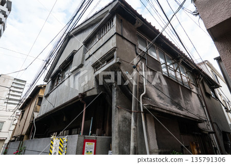 An old two-story wooden house made of mortar from the Showa era An old two-story wooden house made of mortar from the Showa era 135791306