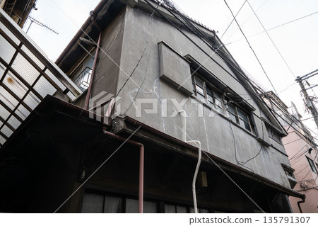 An old two-story wooden house made of mortar from the Showa era An old two-story wooden house made of mortar from the Showa era 135791307