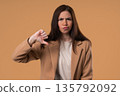 Businesswoman With Sign Of Dislike. Grimacing Student Lady Showing Thumbs-Down 135792092