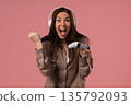 Young Female Gamer Celebrating Victory While Playing Video Games On Pink Studio 135792093
