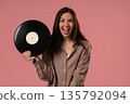 Pretty Woman Smiling With Vinyl Record Disc On Pink. Hobby, Music, Collection 135792094