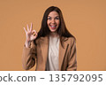 Positive woman forms OK, OKay hand sign, smiling confident. Confirmation,success 135792095
