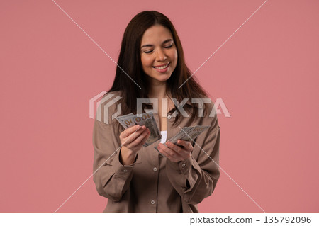Rich Smiling Woman Counting Usd Cash Money Dollars On Pink, Income Payment Rich Smiling Woman Counting Usd Cash Money Dollars On Pink, Income Payment 135792096