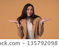 Confused Woman Shrugs Shoulders Showing Uncertainty, Confusion, Hesitation 135792098