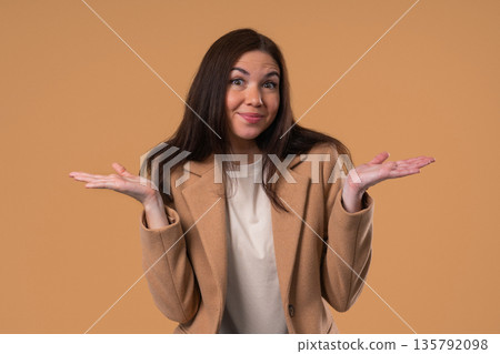 Confused Woman Shrugs Shoulders Showing Uncertainty, Confusion, Hesitation 135792098