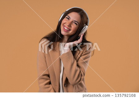 Happy Young Woman In Formal Jacket Listening Music, Dances Wireless Headphones 135792108