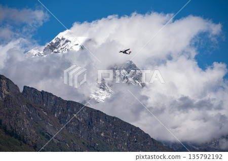 An aircraft flying over the mountains nearly Lukla in Sagarmatha national park, Nepal. While the flight from Kathmandu to Lukla Airport only lasts about half an hour, it could be the most intense air An aircraft flying over the mountains nearly Lukla in Sagarmatha national park, Nepal. While the flight from Kathmandu to Lukla Airport only lasts about half an hour, it could be the most intense air 135792192