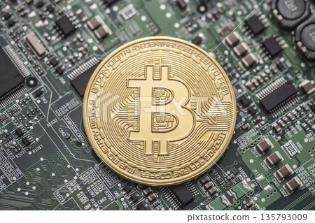 Bitcoin golden coin on green computer circuit board 135793009