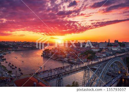 Scenic view of Porto city during sunset with a bridge over the river in Portugal. Scenic view of Porto city during sunset with a bridge over the river in Portugal. 135793037