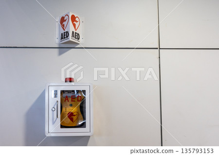 AED or Automated External Defibrillator installed on wall of public places as first aid in heart attack situation. With copy space. AED or Automated External Defibrillator installed on wall of public places as first aid in heart attack situation. With copy space. 135793153