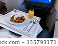 In-flight luxurious business class Asian meal of nasi lemak consisting rice and rendang chicken 135793171