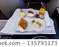 In-flight luxurious business class breakfast served on table cloth and tableware 135793173