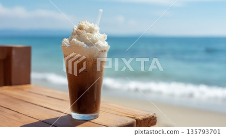 Refreshing iced coffee with whipped cream on a beach table Refreshing iced coffee with whipped cream on a beach table 135793701