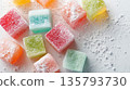 Vibrant Turkish delight sweets are dusted with sugar on white 135793730