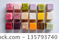 Colorful Japanese mochi cubes are neatly arranged on a clean white background 135793740