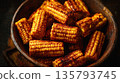Spicy grilled corn cobs piled in rustic bowl 135793745