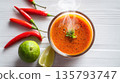 Steaming spicy Thai soup is served with fresh chili and lime 135793747