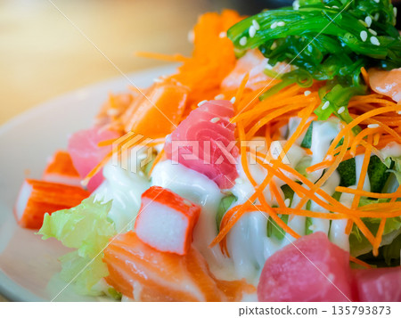 Japanese salad, Raw salmon, tuna, shrimp roe or flying fish roe (tobiko) and crab sticks topped with mayonnaise and seaweed. 135793873