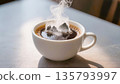 White cup of hot black coffee with thick steam on a table. 135793997
