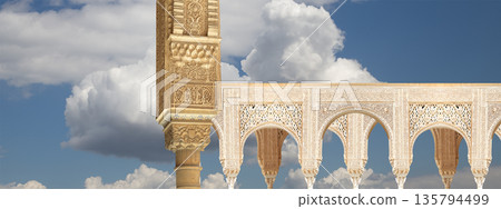 Arches in Islamic (Moorish) style (against the background of a beautiful sky with clouds) in Alhambra, Granada, Spain Arches in Islamic (Moorish) style (against the background of a beautiful sky with clouds) in Alhambra, Granada, Spain 135794499