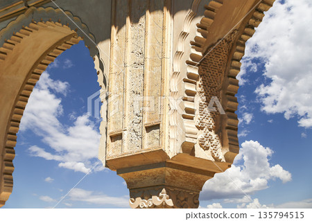 Arches in Islamic (Moorish) style (against the background of a beautiful sky with clouds) in Alhambra, Granada, Spain 135794515