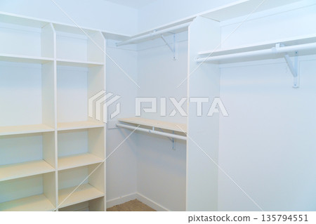 Closet shows open space for shelves hanging rods for clothing other items in house. Closet shows open space for shelves hanging rods for clothing other items in house. 135794551