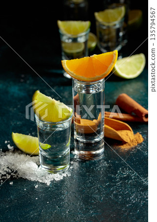 Tequila shots on a black background. Tequila shots on a black background. 135794567