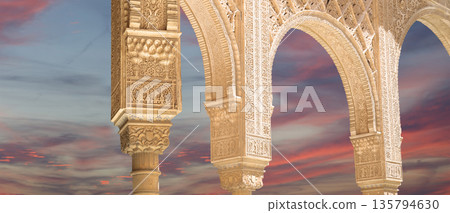 Arches in Islamic (Moorish) style (against the sunset) in Alhambra, Granada, Spain  135794630