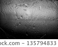 Smooth black plastic surface with light reflections, moody abstract background. 135794833