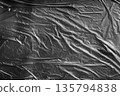 Black wrinkled plastic surface, gritty industrial texture for urban, grunge or packaging design. 135794838