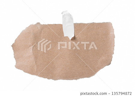 A small piece of brown craft paper with a natural torn top edge and a piece of masking tape attached. Simple design element for notes, price tags, or vintage accents. On a transparent background. A small piece of brown craft paper with a natural torn top edge and a piece of masking tape attached. Simple design element for notes, price tags, or vintage accents. On a transparent background. 135794872
