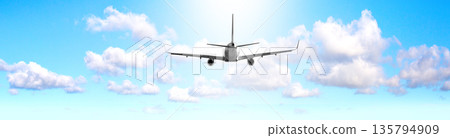Commercial airplane flying high in blue sky with clouds Commercial airplane flying high in blue sky with clouds 135794909