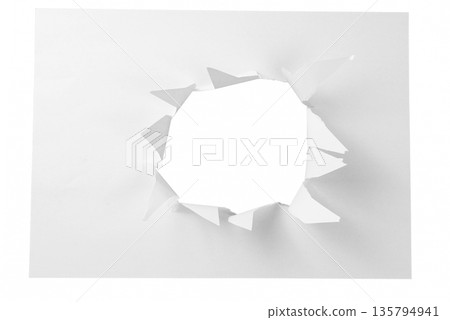 A small, natural torn hole in the center left of a white paper sheet, isolated on a transparent background. A subtle design element for pointing or focus. A small, natural torn hole in the center left of a white paper sheet, isolated on a transparent background. A subtle design element for pointing or focus. 135794941