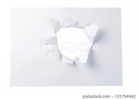 A small, natural torn hole in the top left of a white paper sheet, isolated on a transparent background. A subtle design element for attention or highlights. 135794942