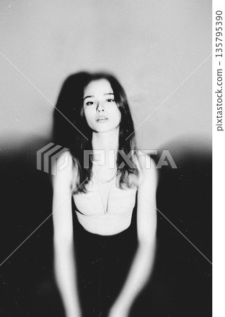 Woman posing with long hair a melancholic monochrome portrait 135795390