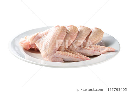 plate with fresh chicken wings isolated on a white background. plate with fresh chicken wings isolated on a white background. 135795405