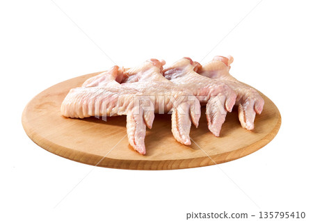 cutting board with chicken wings isolated on a white background. 135795410