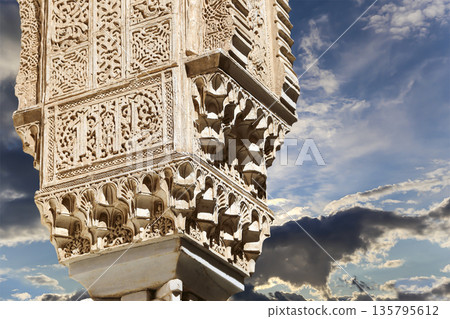 Columns in Islamic (Moorish)  style in Alhambra (against the background of a beautiful sky with clouds), Granada, Spain 135795612