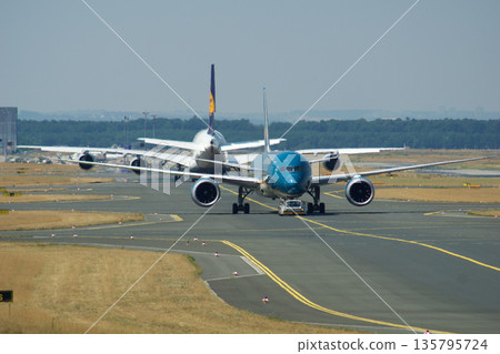 Frankfurt, Germany, July 9, 2017: Boeing 787 and Airbus A380 on Taxiway at Frankfurt Airport Frankfurt, Germany, July 9, 2017: Boeing 787 and Airbus A380 on Taxiway at Frankfurt Airport 135795724