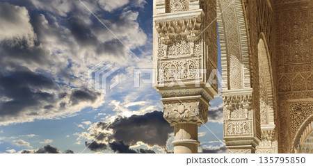 Columns in Islamic (Moorish) style in Alhambra (against the background of a beautiful sky with clouds), Granada, Spain Columns in Islamic (Moorish) style in Alhambra (against the background of a beautiful sky with clouds), Granada, Spain 135795850