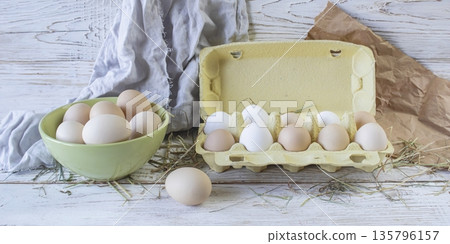 Fresh farm eggs in rustic style on a wooden table. Assortment of fresh farm eggs. Fresh farm eggs in rustic style on a wooden table. Assortment of fresh farm eggs. 135796157