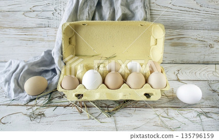 Fresh farm eggs in rustic style on a wooden table. Assortment of fresh farm eggs. Fresh farm eggs in rustic style on a wooden table. Assortment of fresh farm eggs. 135796159