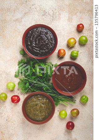 set of tkemali sauces, three types of tkemali sauce, in ceramic bowls, top view, Georgian cuisine, no people, set of tkemali sauces, three types of tkemali sauce, in ceramic bowls, top view, Georgian cuisine, no people, 135796413