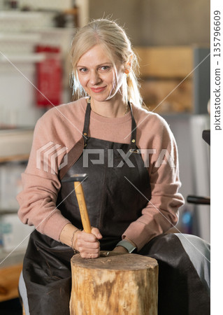 Smiling female artisan working on craft project Smiling female artisan working on craft project 135796609