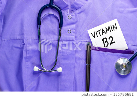 Vitamin B2 riboflavin symbol. Concept words Vitamin B2 on beautiful white card. Stethoscope and pen. Beautiful medical uniform. Medical healthy lifestyle Vitamin B2 riboflavin concept. Vitamin B2 riboflavin symbol. Concept words Vitamin B2 on beautiful white card. Stethoscope and pen. Beautiful medical uniform. Medical healthy lifestyle Vitamin B2 riboflavin concept. 135796691